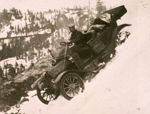 Courtesy Searls Historical Library Arthur Foote behind the wheel of his car descending to Donner Lake. Note the door is open for a quick jump if necessary. Also note the railroad snow sheds in the background.