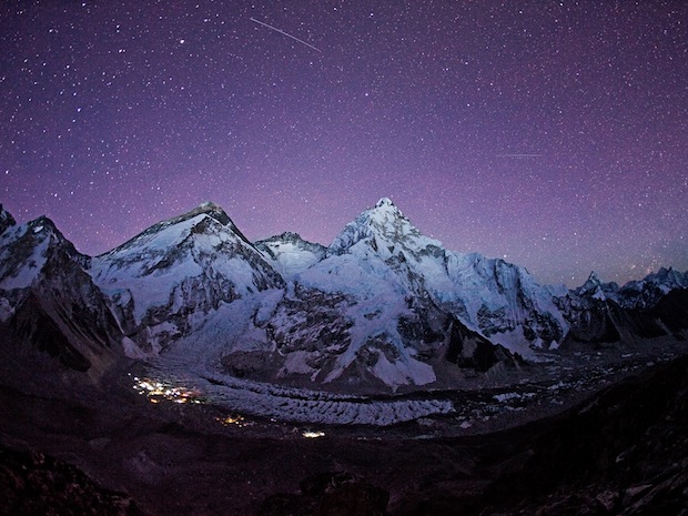 Everest at night with glowing basecamp