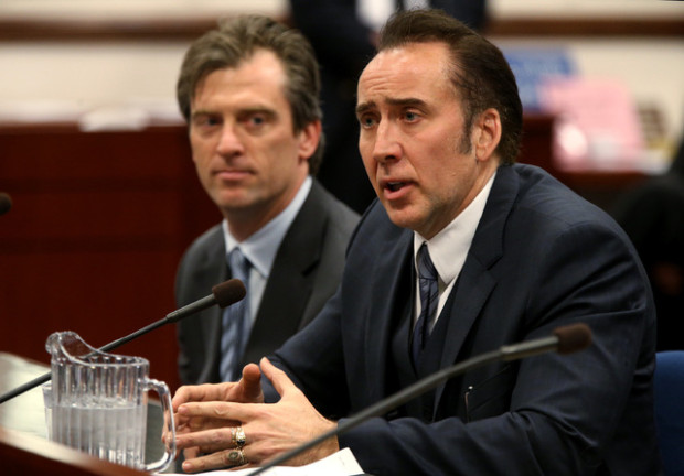 Actor Nicolas Cage testified in support of a bill proposing tax incentives to filmmakers at the Legislative Building Carson City, Nev., on Tuesday, May 7, 2013. Proponents of the measure say it will bring jobs and revenue to the state. Cage's agent Michael Nilon is at left. (AP Photo/Cathleen Allison)