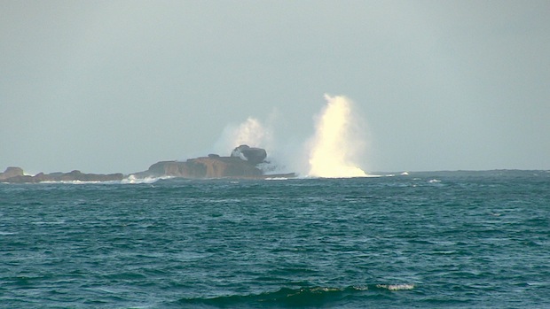Big wave pop off outer reef rock in southeast Lombok