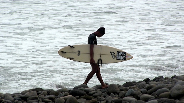 Local surfer navigating the cobblestones