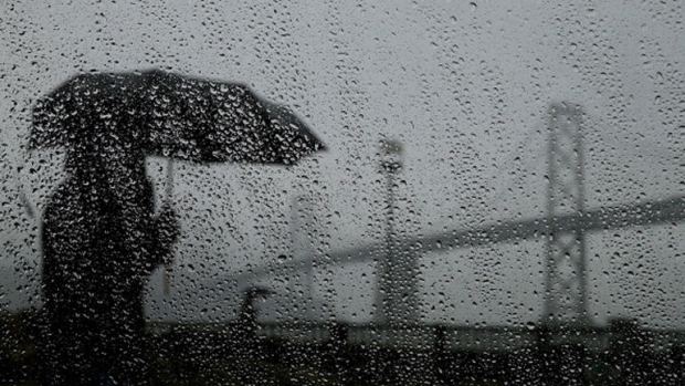 Rain, umbrella, and the Bay Bridge in San Francisco, CA.  photo:  sfgate.com