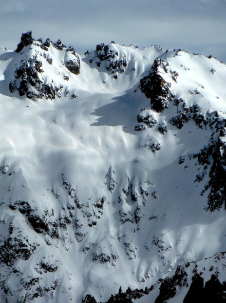 Alaskita starts on the spines in the light on the upper right and continues fall line down the convex slope and onto or between the fingers at the bottom.  On the right day, you ski the spine up top, the big open convexity, the main finger all the way to the bottom, then you get more big open glory turns all the way to the creek in the Van Titter valley.  August 24th, 2013.  photo:  snowbrains.com