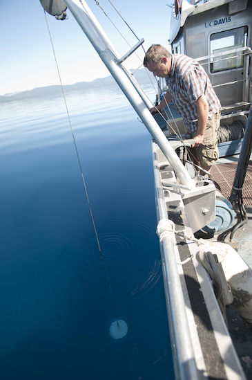 Raph Townsends drops a  Secchi disk and marks the depth when the disk disappears to check water clarity at Lake Tahoe, California on Thursday June 6, 2013.  The UC Davis Tahoe Environmental Research Center does testing, monitoring, and conservation on the lake.