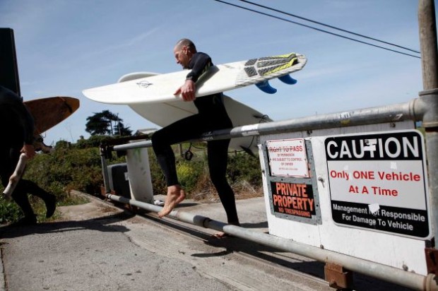 Surfer entering the private road to Martins beach on September 27th, 2014.  The gate remained closed even after a court order said it was to be opened.