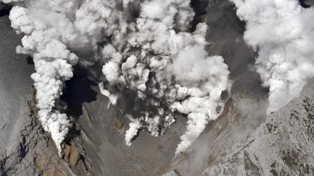 Dense fumes spewed out from several spots on the slope of Mt. Ontake as the volcano erupts in central Japan Saturday, Sept. 27, 2014 (AP Photo:Yomiuri Shimbun, Toshihiko Kawaguchi)