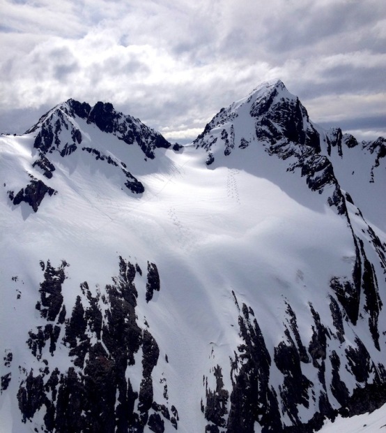 Guide tracks on a backbowl peak behind the Martial Glacier.