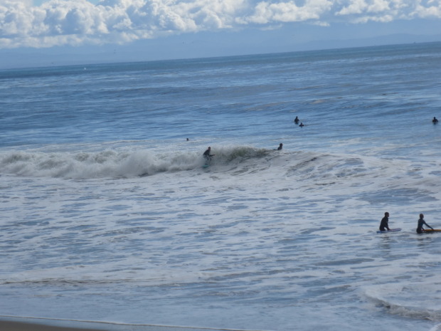 People still surfing in sub par conditions. Two bodyboarders hit the shore break showing the diversity of the surf spot.