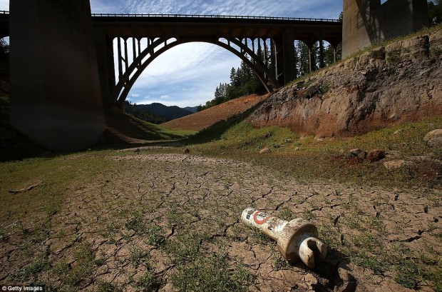 A buoy sits on cracked earth at the bottom of a dry inlet of Shasta Lake on August 30, 2014 in Lakehead, California