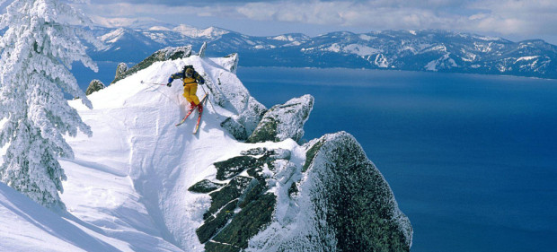 Dropping into the Lake Tahoe backcountry with Lake Tahoe in the background.