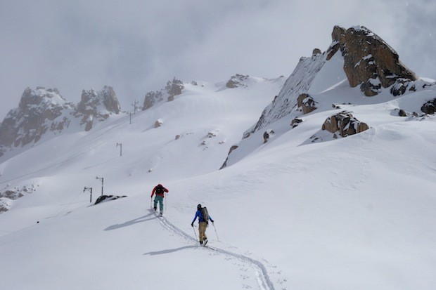 Two SASS guides skinning up La Laguna at Catedral ski resort in Bariloche, Argentina in August 2014.  photo:  snowbrains