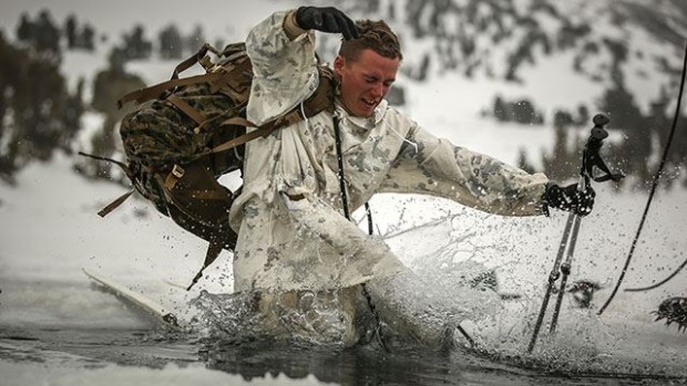Sgt. Sloan Seiler, Winter Mountain Leaders Course 1-15, student, Marine Corps Mountain Warfare Training Center, and 1st Lt. Mancelino Figueroa, WMLC 1-15, class commander, 1st Battalion, 3rd Marine Regiment, lead a line of Marines pulling a block of ice back into Levitt Lake at the MCMWTC, Bridgeport Calif., Jan. 30, 2015. The blocks of ice that were cut out of the lake were returned after the Marines concluded training. (Official Marine Corps photo by Cpl. Charles Santamaria/Released)