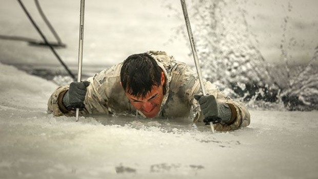 Cpl. Jacob Mattison, Winter Mountain Leaders Course 1-15, student, 1st Battalion, 3rd Marine Regiment, native of Mankato, Minn., digs his ski poles into the ice to gain enough leverage to climb his way out of freezing water during an Ice-Breaker Drill as part of WMLC 1-15 at Levitt Lake, Marine Corps Mountain Warfare Training Center, Bridgeport, Calif., Jan. 30, 2015. Once the students got out of the water, they sprinted to the warming tents, where they stripped off their wet clothing and put on dry clothes to restore their body’s normal temperature. (Official Marine Corps photo by Cpl. Charles Santamaria/Released)