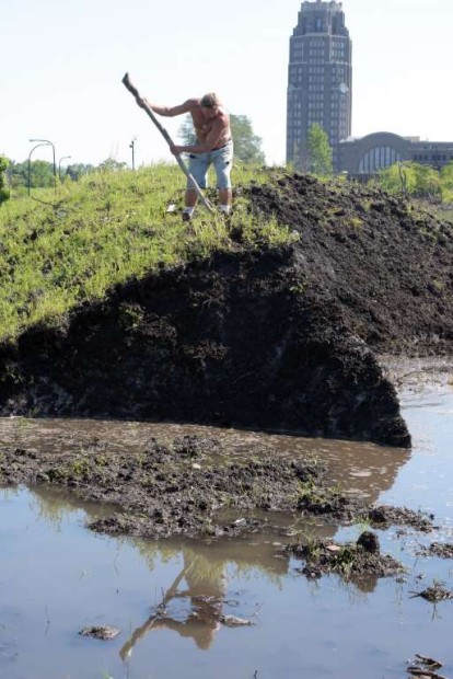 © AP Photo/Gary Wiepert Robert A. Raczka uses a stick on top of this dirt-covered snow "glacier" that still hasn't melted at the Central Terminal on Buffalo's East side eight months ago, Tuesday, July 28, 2015.