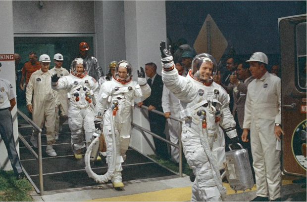 Neil Armstrong waving in front, and the crew or Apollo 11, head for the van that will take the crew to the rocket for launch to the moon at Kennedy Space Center in Merritt Island, Florida, on July 16, 1969. #