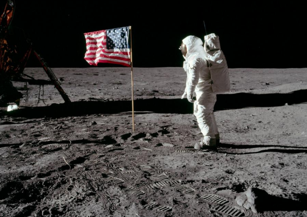 Buzz Aldrin salutes the deployed United States flag during the Apollo 11 Extravehicular Activity (EVA) on the lunar surface. Astronaut Neil Armstrong took this picture with a 70mm Hasselblad lunar surface camera