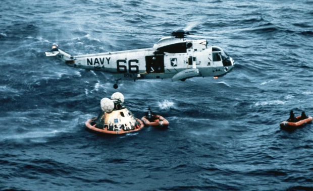 Apollo 11 crew boarding a recovery helicopter after a successful splashdown on July 24, 1969