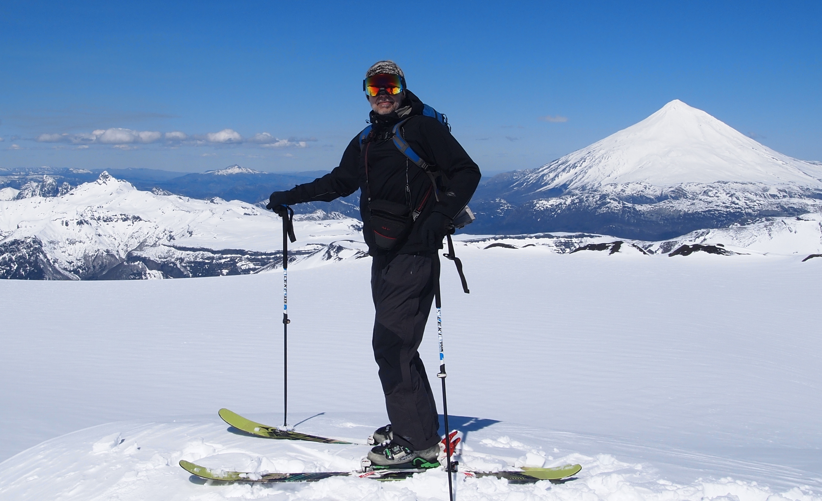 Yours truly admires the view, with the crater, Volcan Lanin (3,750m) and the fang of Quinquilil Volcano in the back.