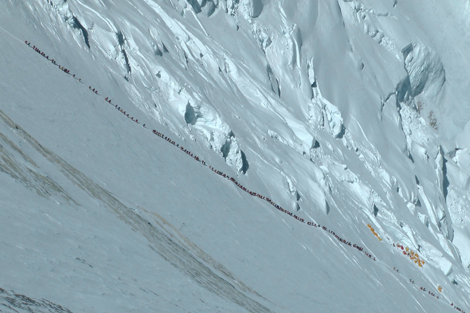 Everest climbers form a long snaking line up the mountain as they strive to reach the summitEverest climbers form a long snaking line up the mountain as they strive to reach the summit
