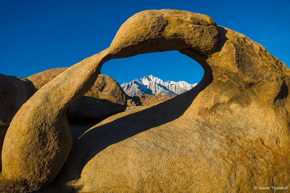 Snow covered Mt. Whitney is framed by Mobius Arch in the Alabama Hills outside of Lone Pine, California. photo: