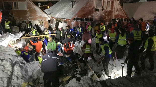 Search and rescue crews work after an avalanche hit several houses in Longyearbyen, Norway, Saturday Dec. 19. 2015. It is unclear about the number of people caught in the avalanche but authorities are calling for volunteers with shovels to help in the search to locate victims. (NTB scanpix via AP) 