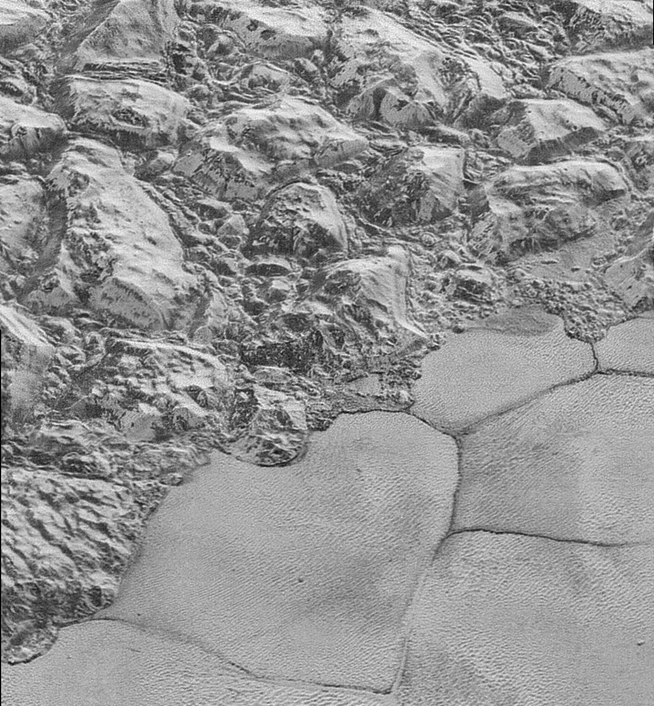 The Mountainous Shoreline of Sputnik Planum: In this highest-resolution image from NASA’s New Horizons spacecraft, great blocks of Pluto’s water-ice crust appear jammed together in the informally named al-Idrisi mountains. "The mountains bordering Sputnik Planum are absolutely stunning at this resolution," said New Horizons science team member John Spencer of the Southwest Research Institute. "The new details revealed here, particularly the crumpled ridges in the rubbly material surrounding several of the mountains, reinforce our earlier impression that the mountains are huge ice blocks that have been jostled and tumbled and somehow transported to their present locations." Credits: NASA/JHUAPL/SwRI