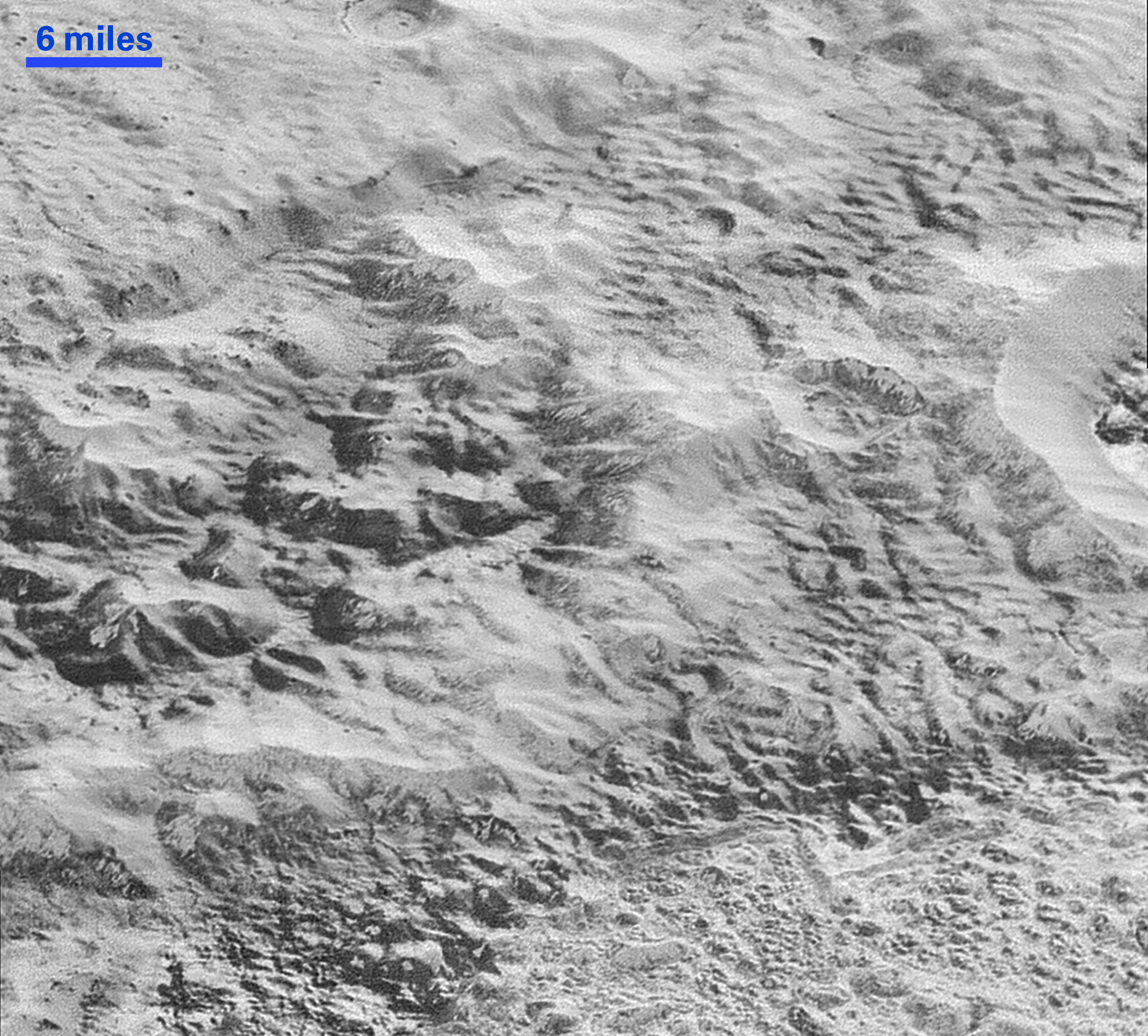 Pluto’s ‘Badlands’: This highest-resolution image from NASA’s New Horizons spacecraft shows how erosion and faulting have sculpted this portion of Pluto’s icy crust into rugged badlands topography. Credits: NASA/JHUAPL/SwRI