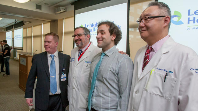 Smith standing with some of his doctors that helped save his life nearly a year after the incident