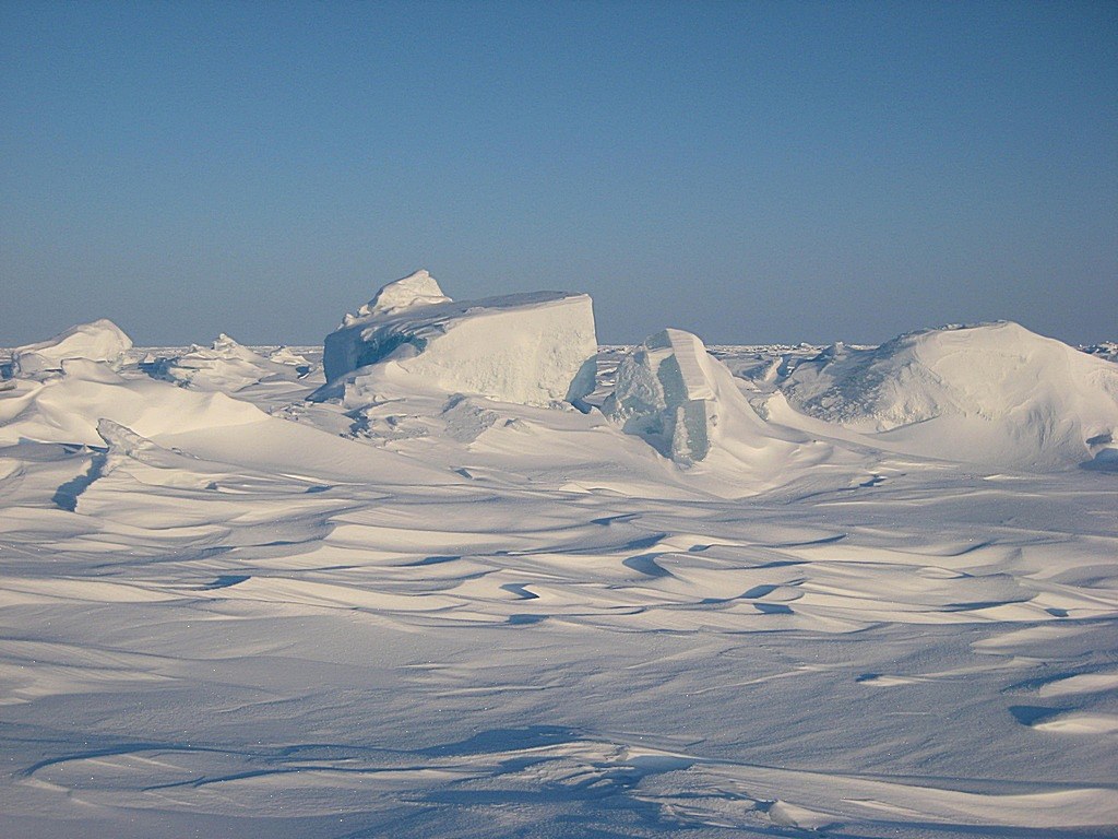 The North Pole is sea ice and looks the like above picture. Attempts to physically mark the exact spot drift away as the sea ice shifts. 
