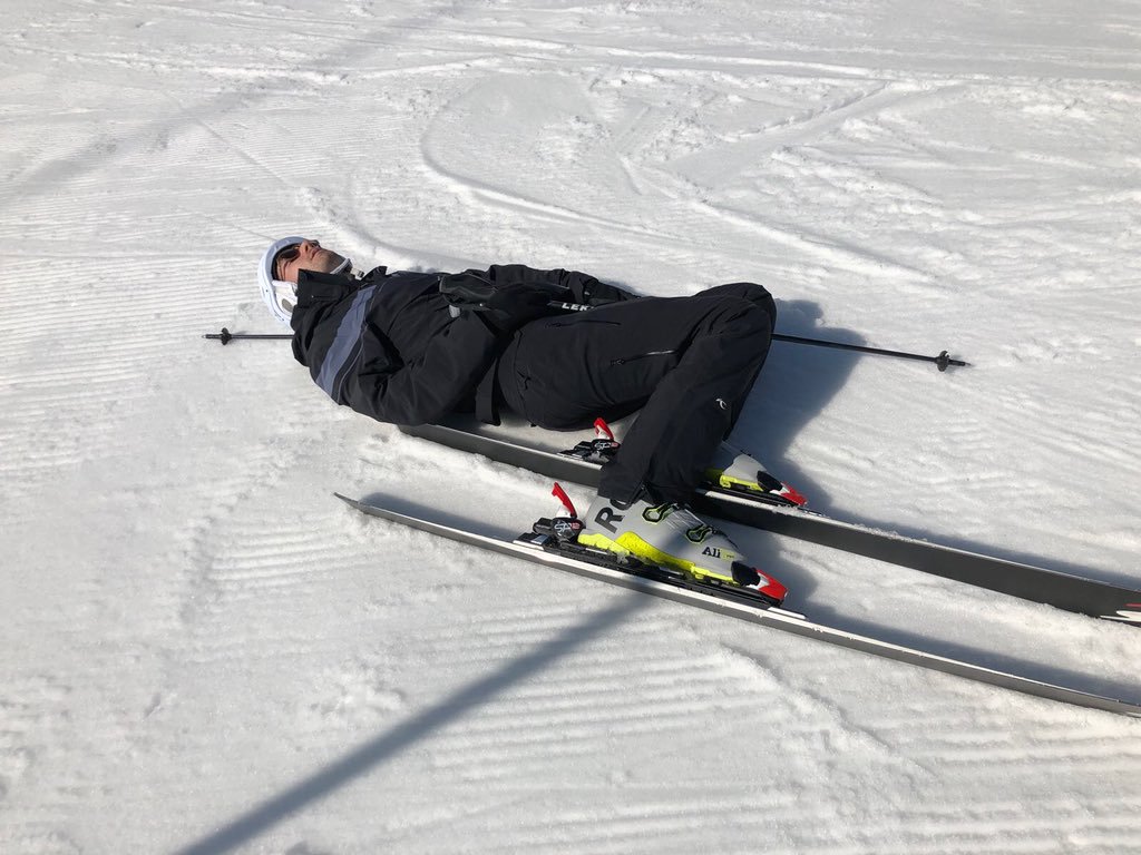 A skier laying on the ground, presumably from a hangover