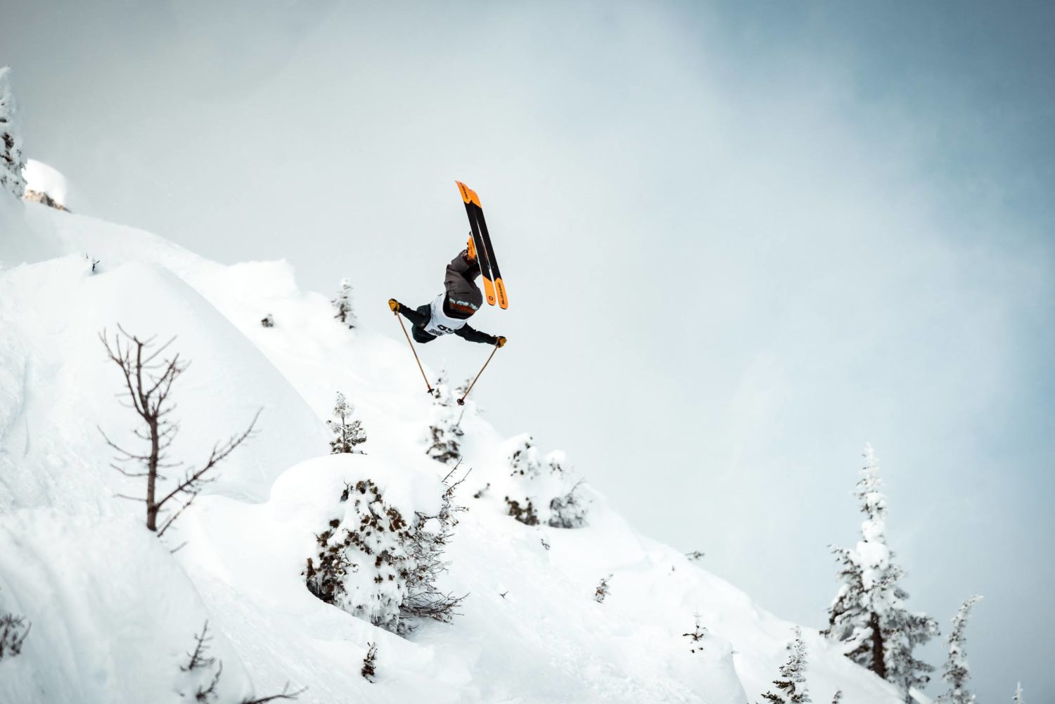 Skier hucks a backflip at the freeride world qualifiers at kicking horse