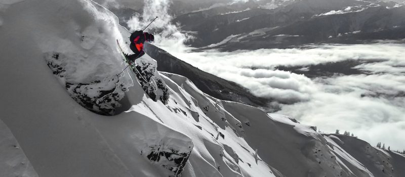 Miles Clark jumping off cliff into couloir