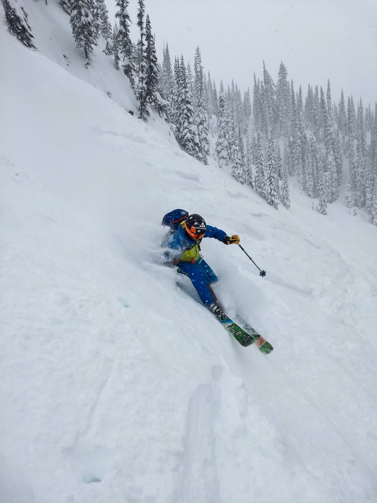 Skier slashing through powder in Revelstoke