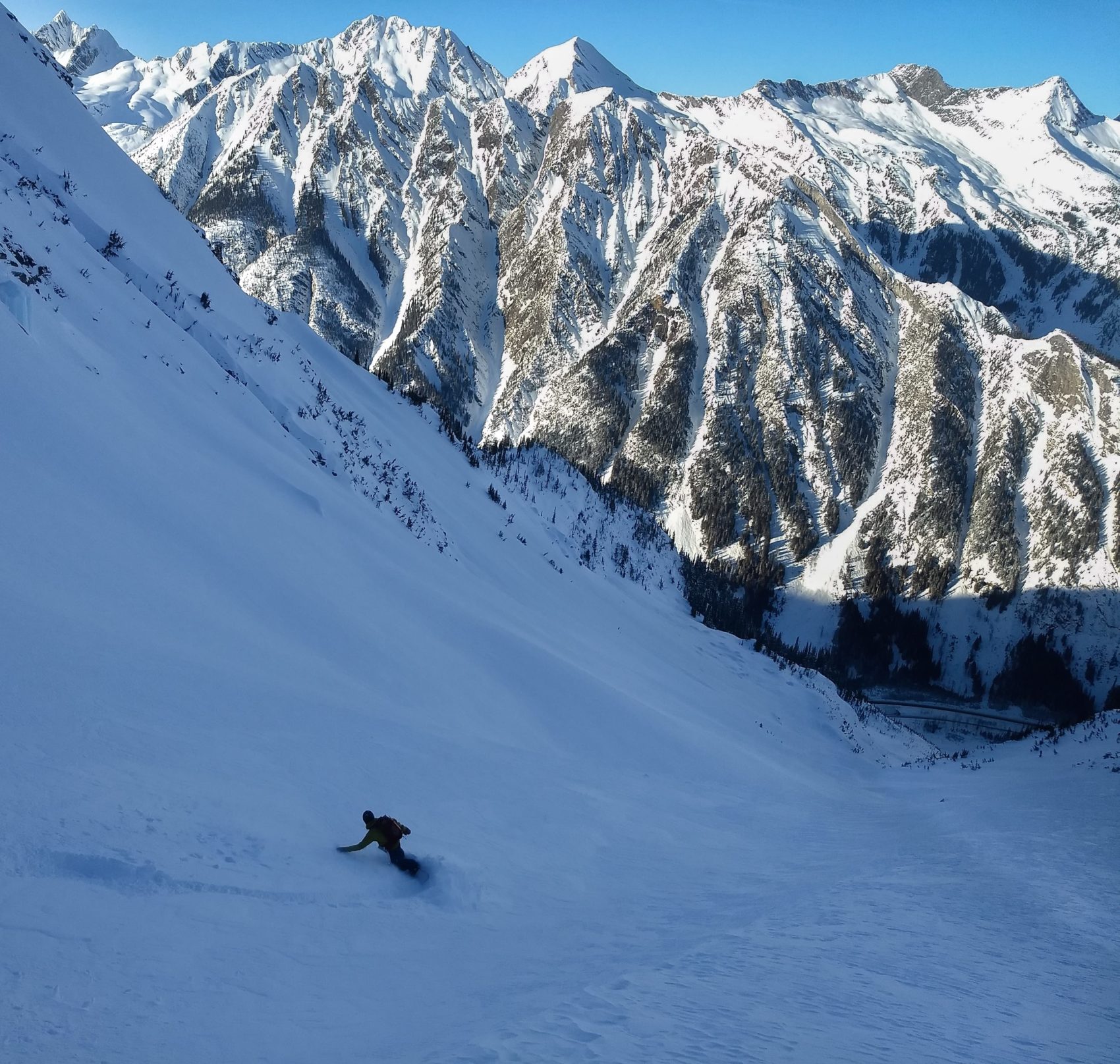 snowboarder riding down ross peak path