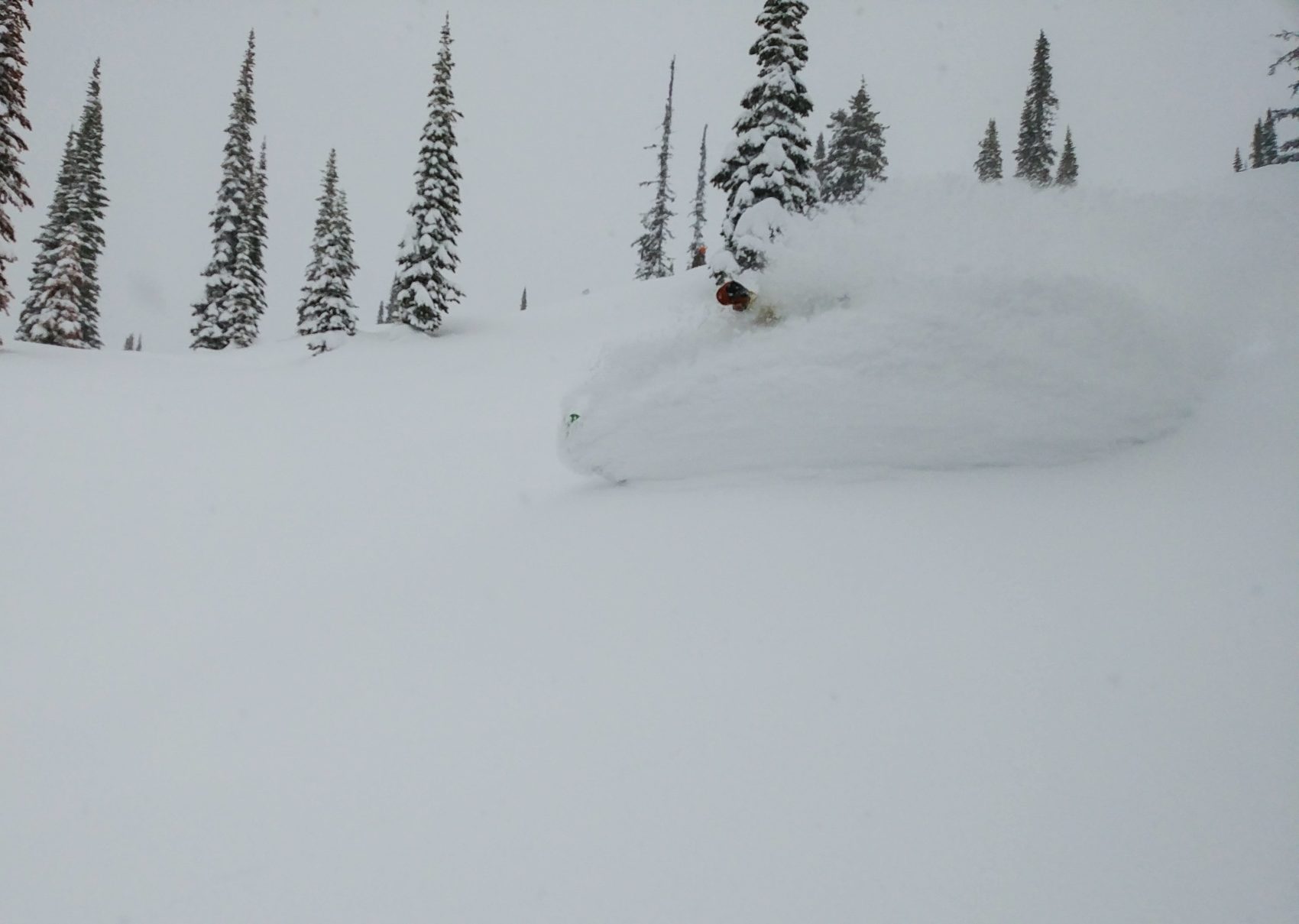 snowboarder slashing powder