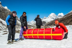 Climbers utilizing a Gamow Bag to simulate an increase in air pressure to treat altitude-related illnesses