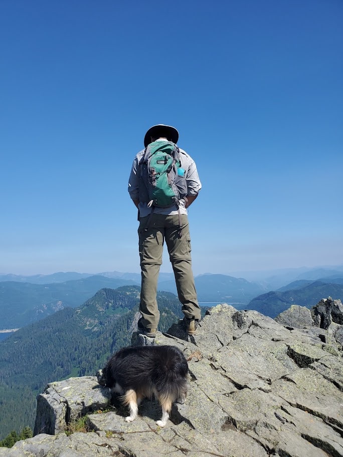 Man standing on cliff, pissing, 