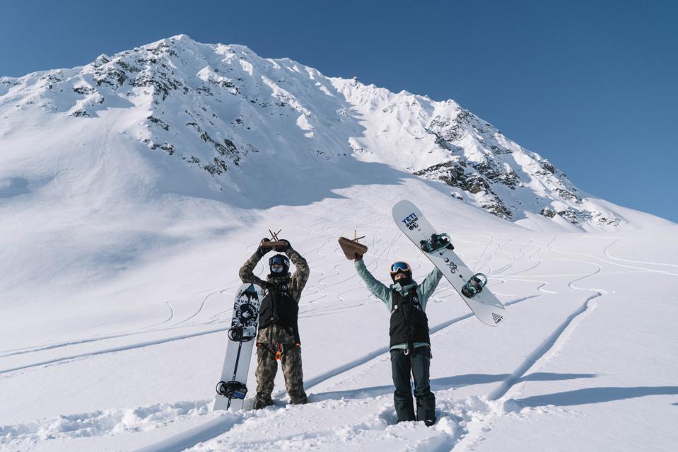 Natural Selection Tour winners Mikkel Bang and Robin Van Gyn celebrate their victories below the course at Tordrillo Lodge, Alaska. 