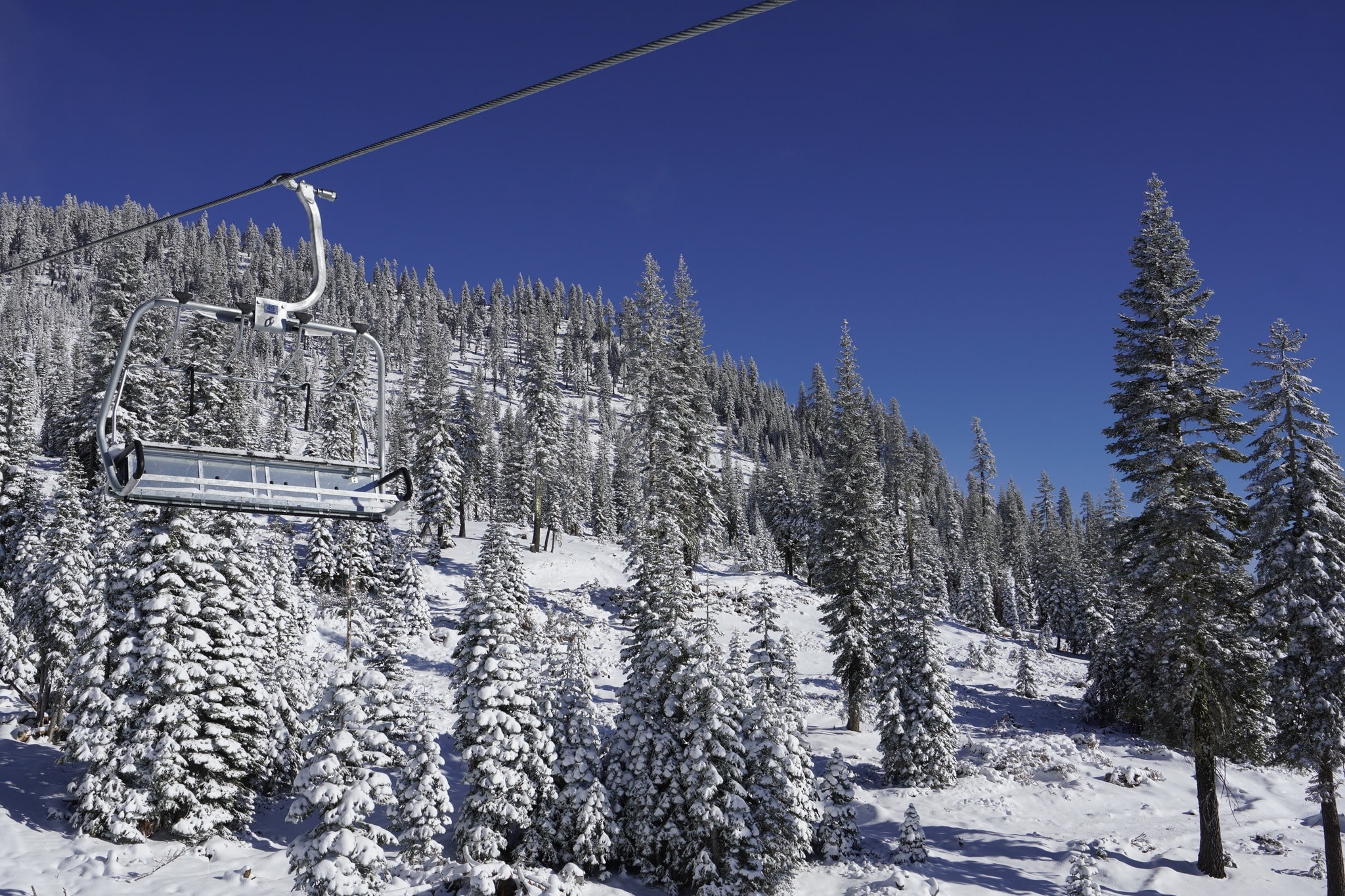 Grey Butte lift with woods skiing in background