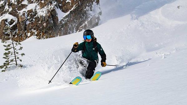 A skier makes soft turns in deep snow at Crystal Mountain Washington