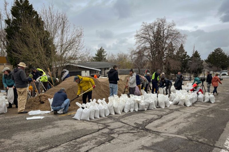 Sandbag teams work to divert water from Emigration Creek