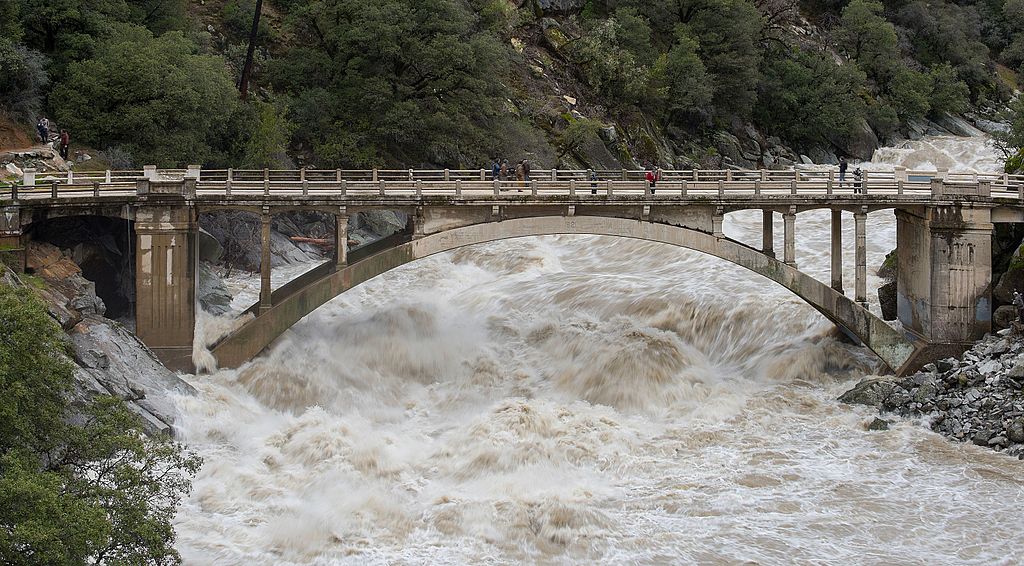 flooded bridge from raging snowmelt water