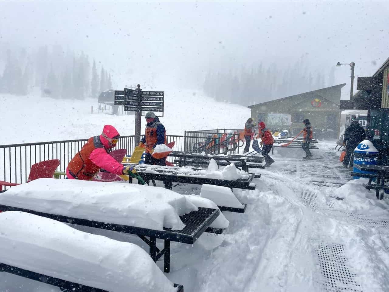 employees clear deep snow from tables and decking at monarch mountain colorado