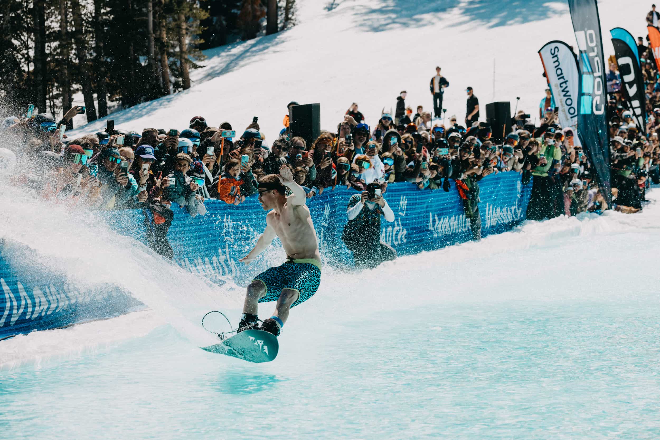 Half naked snowboarder at Mammoth Mountain pond skim in spring