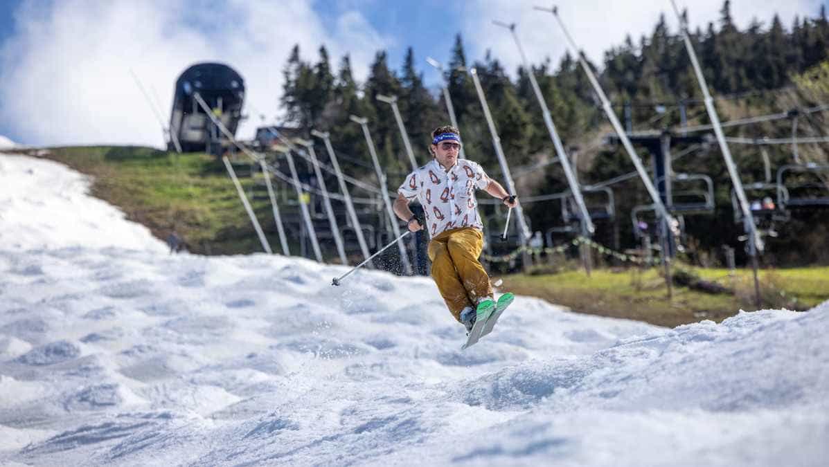 A skier jumps down the moguls on superstar at killington