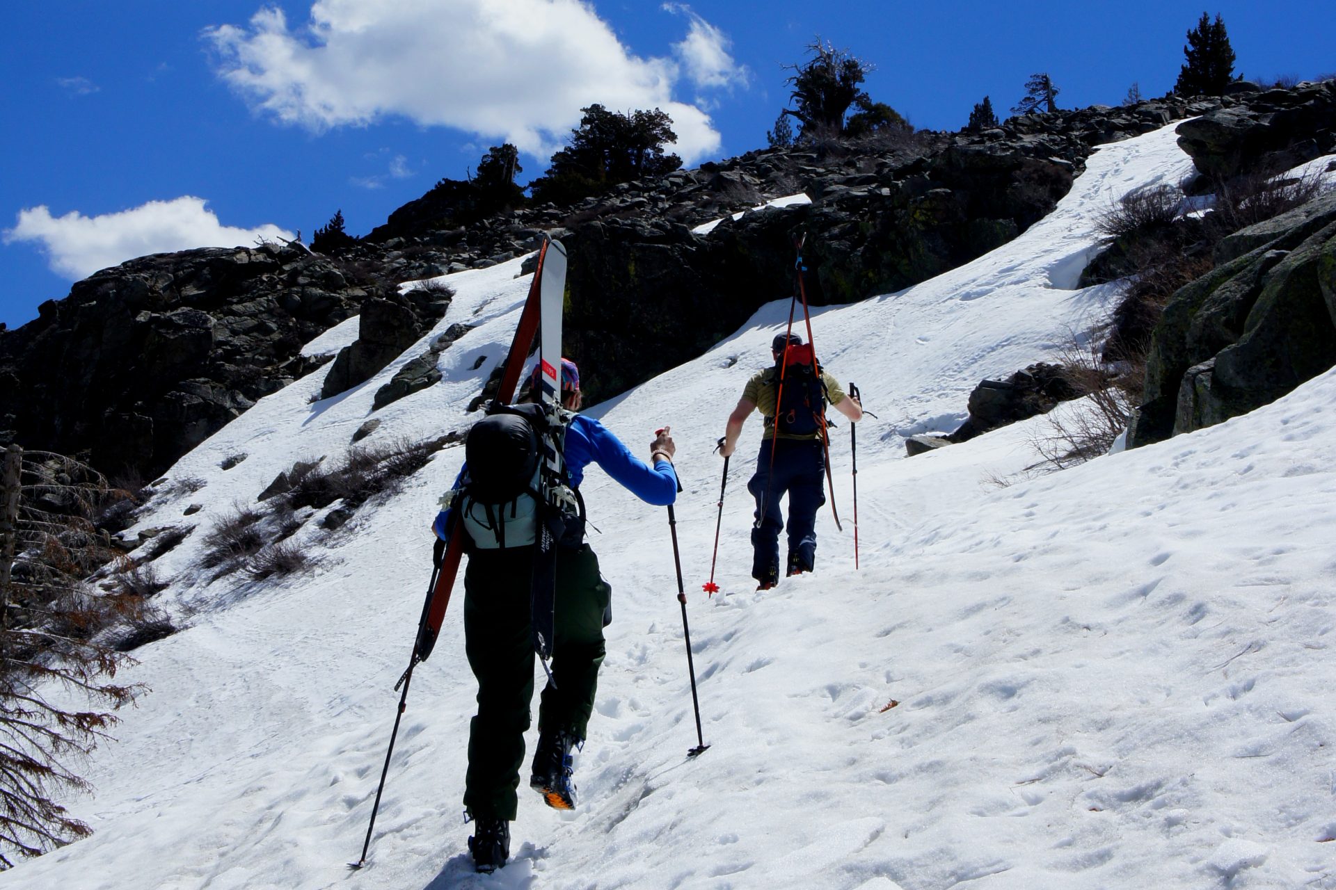 two skiers boot packing up steep slope on donner peak
