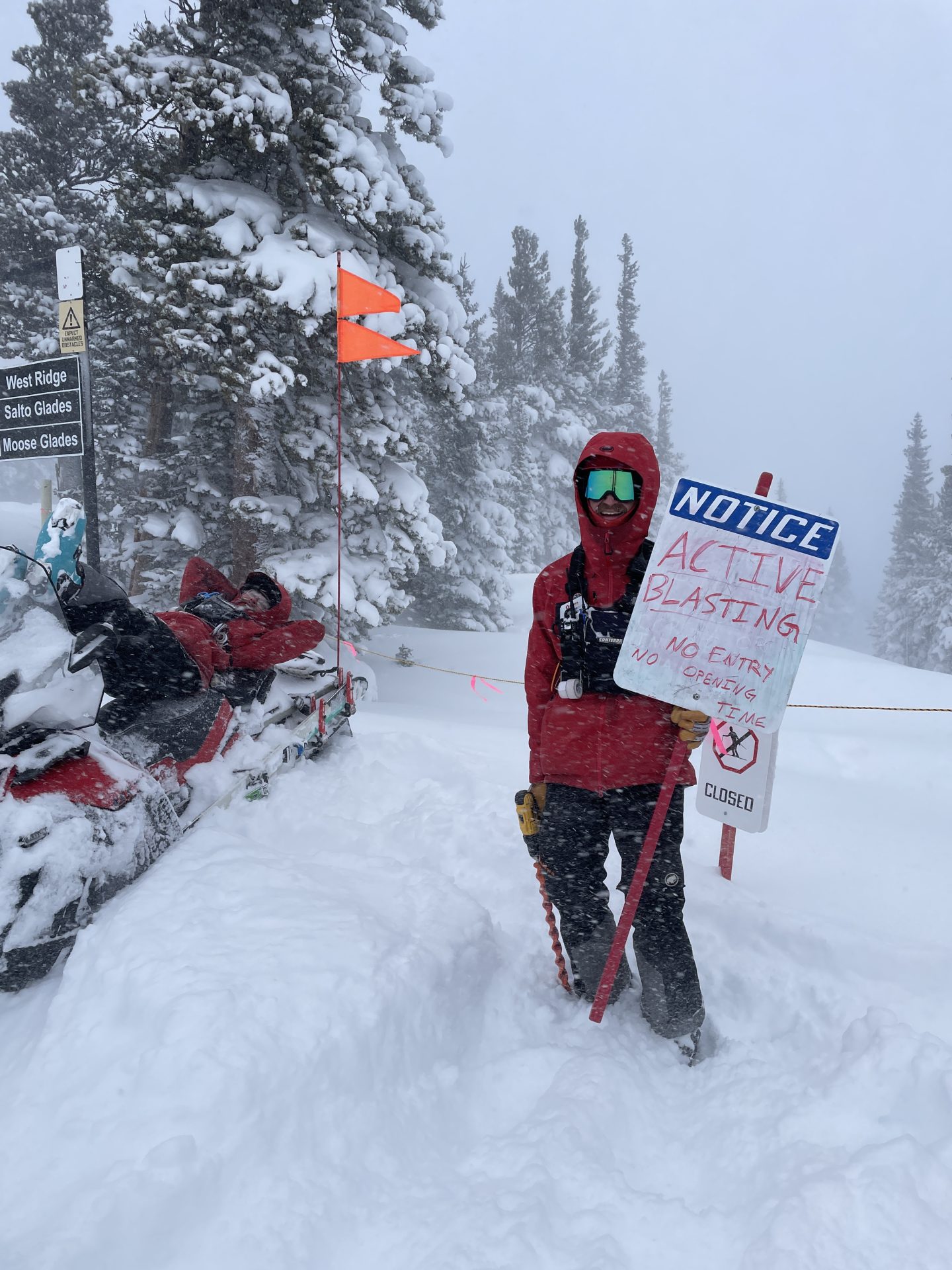 eldora ski patroller with sign warning of explosives