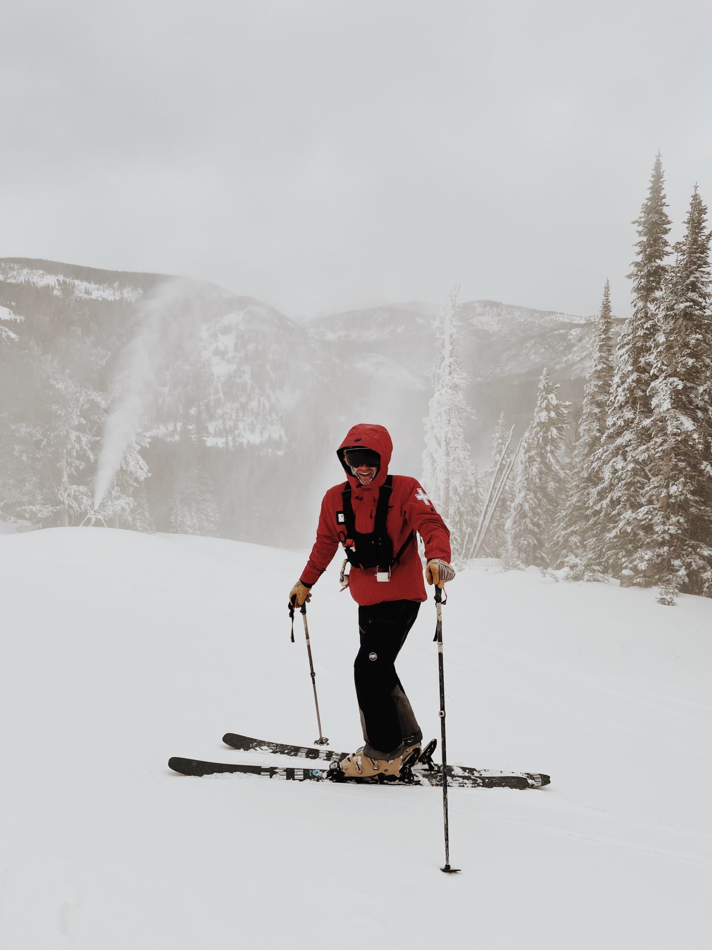 eldora ski patroller in front of snow making equipment