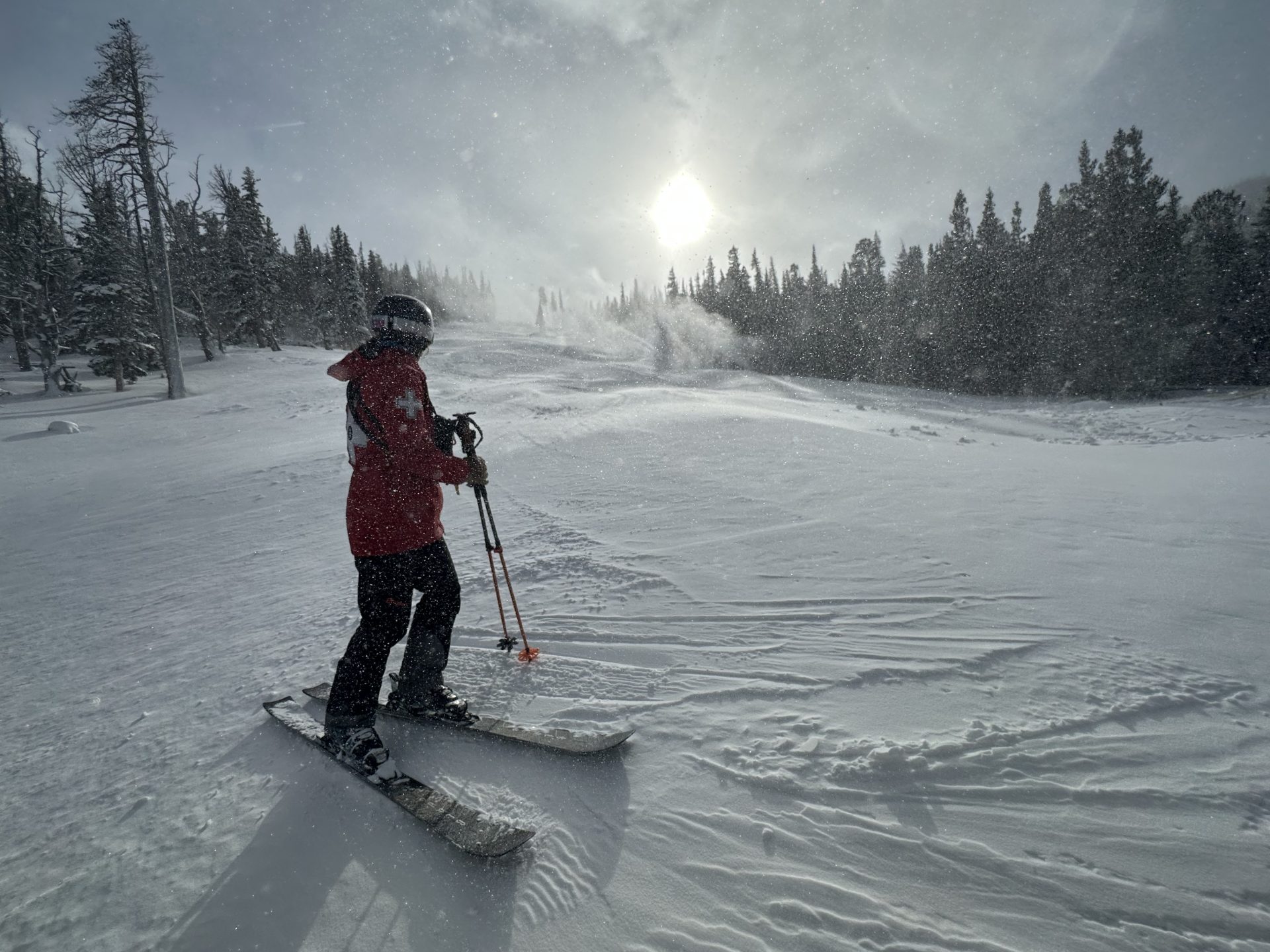 eldora ski patroller with low sun in the background