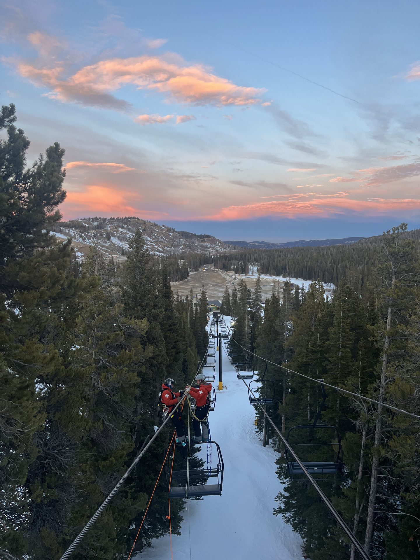 eldora patrollers practicing chairlift evacuation with sunset in the background